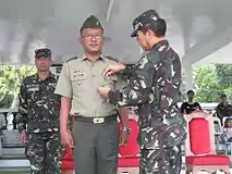 Newly promoted CPT ROMEO C MENDOZA (RES) PA is awarded by BGEN MARCELO B JAVIER JR (RES) AFP; commanding general.15th Infantry Division, ARESCOM with the Military Merit Medal for his contributions to TF Maring.