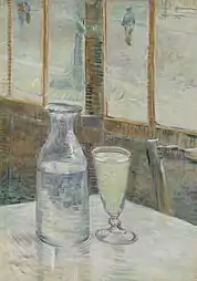 A table in a cafe with a bottle half filled with a clear liquid and a filled drinking glass of clear liquid