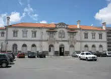 Railway station. Two-story white building with terra-cotta roof. "Caldas da Rainha" written atop center of façade.