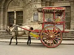 Image 37Kalesa, a traditional Philippine urban transportation, in front of Manila Cathedral entrance (from Culture of the Philippines)