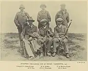 Team photograph of a rifle shooting team, in black and white.