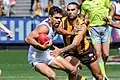 Charlie Cameron fends to the shoulder of Shaun Burgoyne