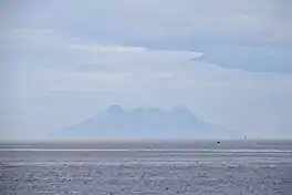 Silhouette of Mt. Timpoong (L) and Mt. Mambajao (R), the highest peaks of the largest mountain in Camiguin, as seen from the north, across Bohol Sea