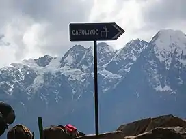 Signs for tourists at the viewpoint of Incahuasi with Padreyoc in the background.