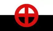 The "ensign" of the Canadian Nationalist Party, in practice its second party flag. It is a white (top) and black (bottom) bicolour charged with a red cross within a red circle in the centre.