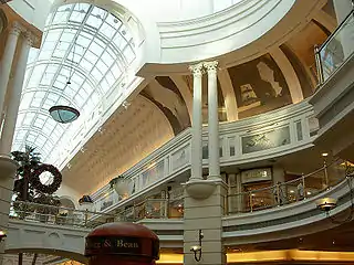 Atrium-like glass ceilings provide natural light to the double-story mall.