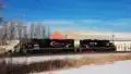 CCGX 4206 and CEMR 4002, bring a freight train into Winnipeg, Manitoba