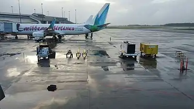 Caribbean Airlines Boeing 737-800 with a ride range of Airport ground support equipment