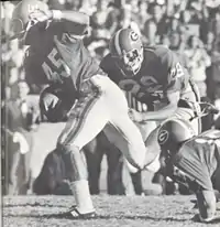 Carlos Alvarez running with the ball, guarded by another Gator