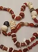 Necklace of beads made from carnelian, bone and stone. It is thought that carnelian jewellery found in the UAE originated in the Indus Valley.