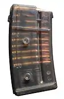 Detachable box magazine for a SIG 550 with studs for stacking multiple magazines together.