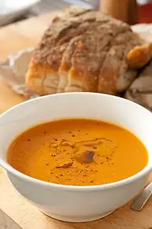 A cream of carrot soup with bread