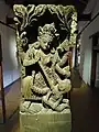 Carving of religious deity on wooden pillar