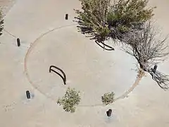 Close-up view of the second calibration target manhole cover. Around the cover protrude six equidistant pieces of rebar.