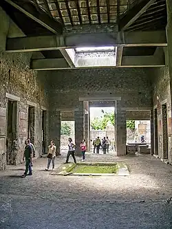 Tuscan atrium. Impluvium is mossy; behind, the main door is flanked by two shops. House of Sallust, Pompeii (floorplan).