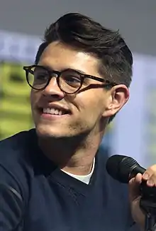 Photo of a bespectacled man with a microphone