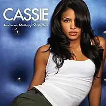 A portrait of Cassie posing in a white tank top. Her name and the song title appear on the left in white text.