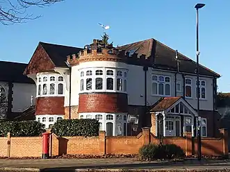 Corner house with round castellated tower, 20th century