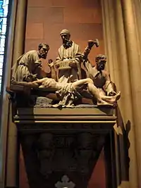 Small stone statuary, mounted on a wall, depicting the crucifixion of Jesus in the Cathedral of the Immaculate Conception