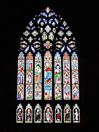An elaborate, tall and wide stained glass window depicting the life of the Virgin Mary