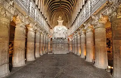 Cave with carved columns and a shrine in the middle