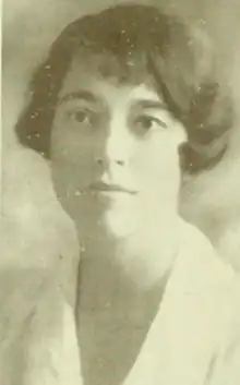 A young white woman with bobbed dark hair, wearing a white collared blouse.