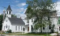 Main street of Center Conway, New Hampshire. On the right is the old Town House, and on the left is the United Methodist Church.