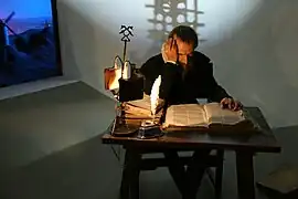 Miguel de Cervantes at his writing desk