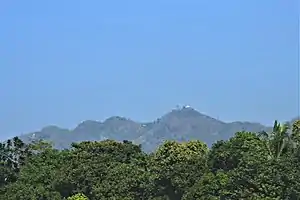 Chandranath Hill, also known as Sitakunda Hill, as seen from the Dhaka-Chittagong railroad. It is the tallest peak in Chittagong district, and is the location of Chandranath and Birupakkha temples.