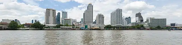 A lot of buildings on a riverbank