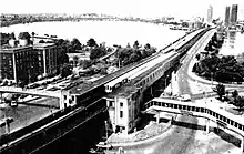 An aerial view of an elevated railway station with footbridges on either side