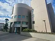 The front of the college, with a circular architectural section attached to a rectangular building.