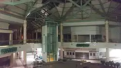 The mostly abandoned interior of Charlestowne Mall, a two-story shopping mall.