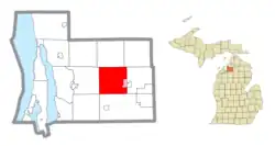 Location within Antrim County (red) and an administered portion of the Alba community (pink)