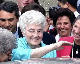 Chiara Lubich, smiling, surrounded by other smiling people