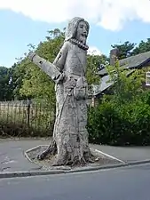 A wooden sculpture formerly opposite the church but now removed