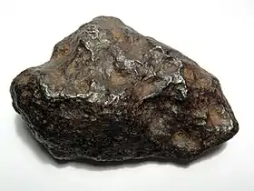 A 700-gram (25 oz) individual Chinga iron meteorite (Ataxite, class IVB). This specimen is about 9 centimeters wide.