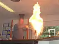 Pouring a very small amount of water into the fire ejects a plume of fire