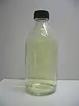 A transluscent pale yellow gas in a sealed bottle