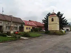 Centre of Chomýž with belfry and cross
