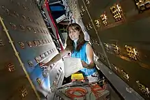 white woman with brown hair and glasses working with relativistic heavy ion collider at Los Alamos National Laboratory