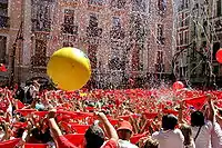 Seconds before the beginning of the San Fermín Festival - Town Hall Square: Everybody has a red handkerchief above their heads until a firework is exploded at 12 pm; putting it around their neck afterward.