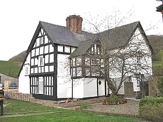 The older timber-framed house on the NW side