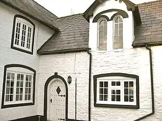 Victorian brick extension with arched dormer windows and arched doorway