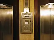The elevator lobby of Hilton Cincinnati Netherland Plaza displays Art Deco style with original postal drop box