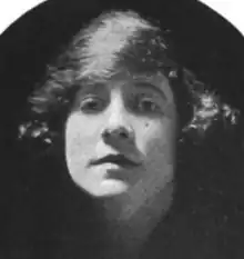 A young white woman with bobbed hair brushed over her forehead
