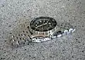 A watch with a segmented stainless steel watch bracelet.
