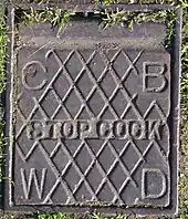 A cast-iron City of Birmingham stopcock cover, on the boundary of a residential property, from the time when the City Council was responsible for the supply of drinking water.