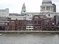 Baynard House and Faraday Building (green roof) on the left, City of London School centre on the north bank of the River Thames, London. Shows height of construction restriction.