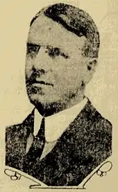 Black and white photo of a man wearing a suit and tie